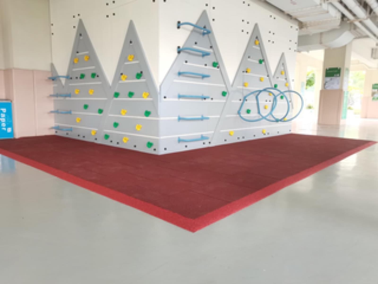 Red EUROFLEX safety mat under climbing wall
