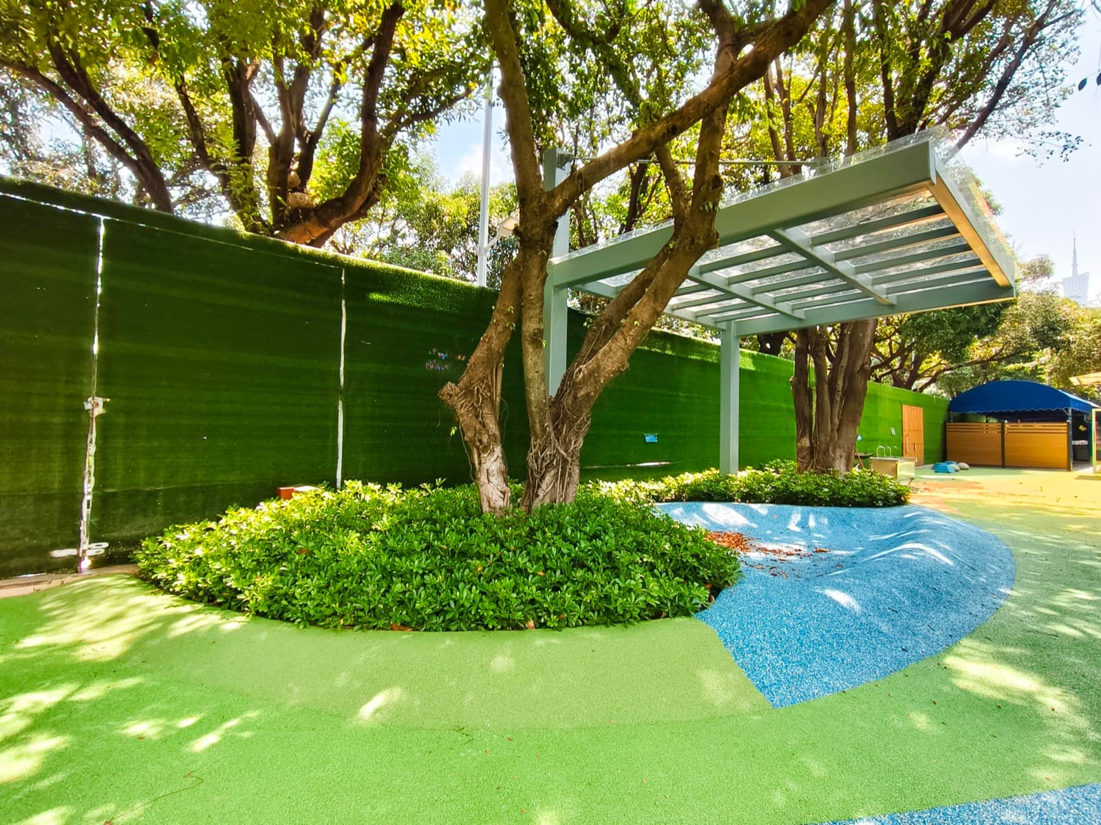 Ground-level view of the green EPDM with blue curved patterns