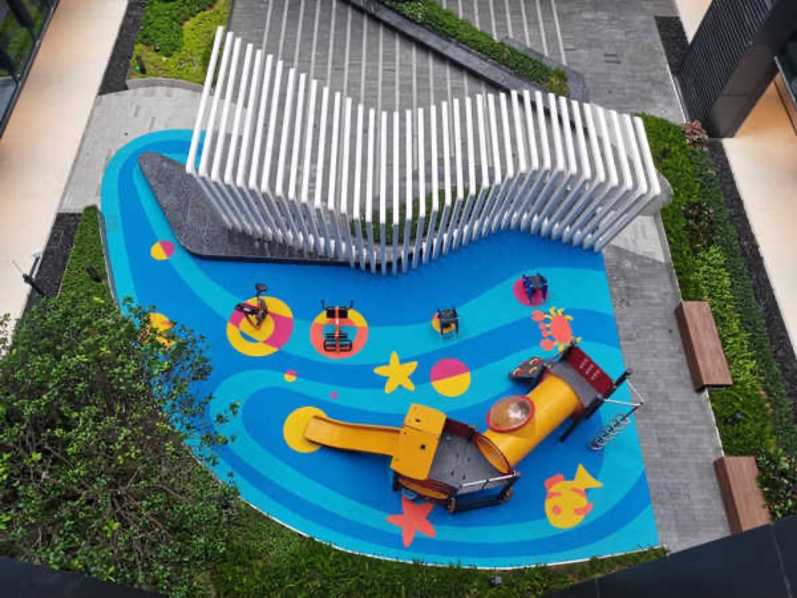 Aerial view of the blue-themed rooftop playground with play equipment