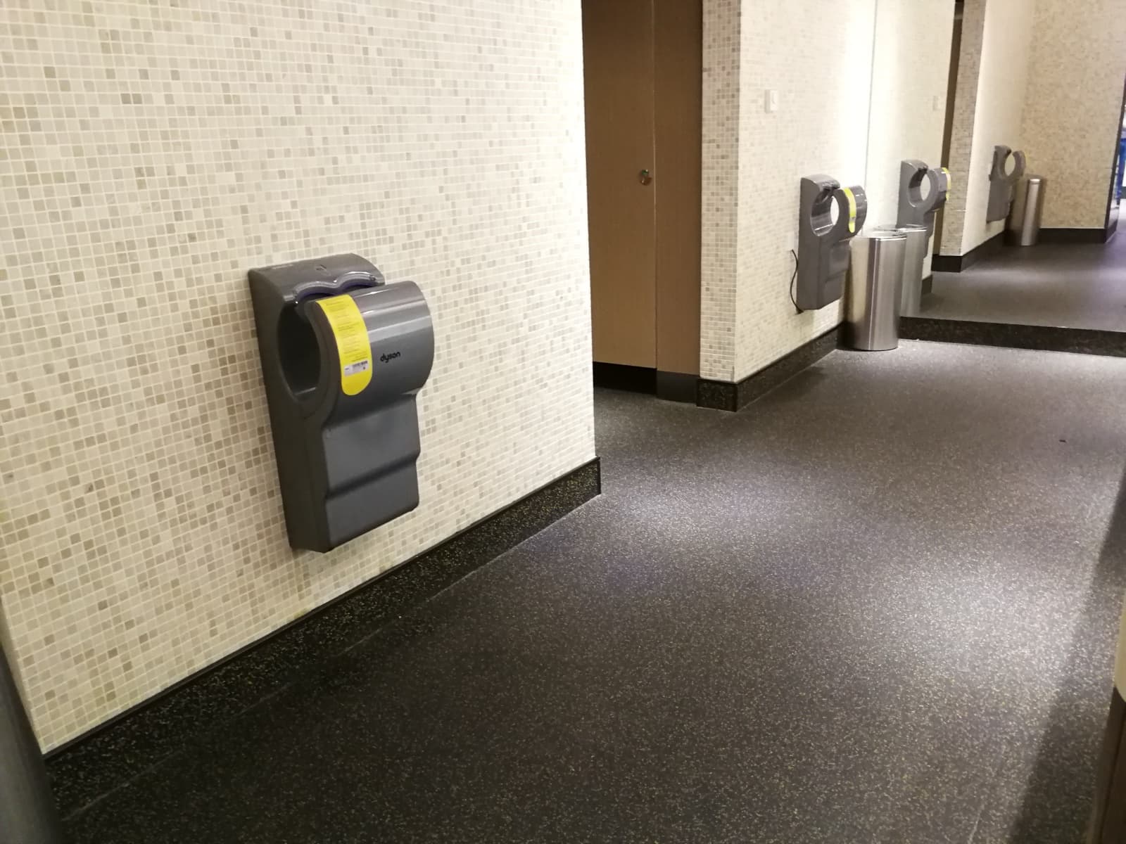 Yellow-speckled rubber floor and skate rental area